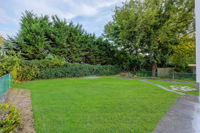 a white house with a white roof and a yard