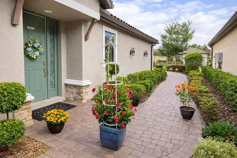 a front view of a house with a flower garden