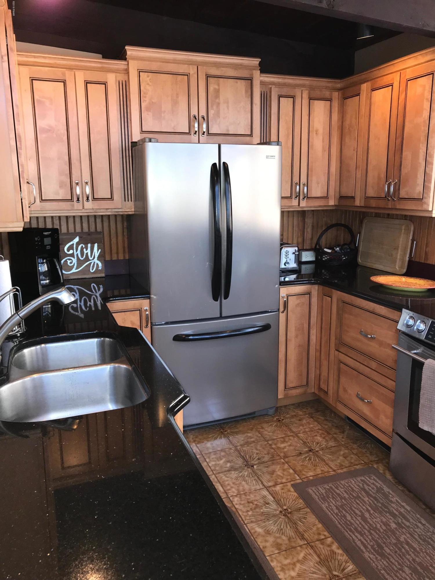 819 Wargo Road Union Dale, PA 18470 - Photo 14 of 49 a kitchen with granite countertop a sink stainless steel appliances and cabinets