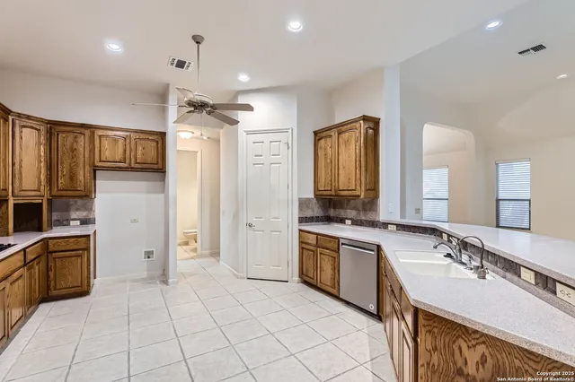 a large kitchen with cabinets and stainless steel appliances
