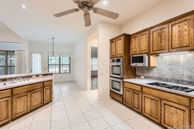 a kitchen with stainless steel appliances granite countertop a stove and a refrigerator