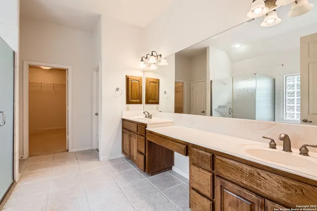 a spacious bathroom with a granite countertop sink mirror and double