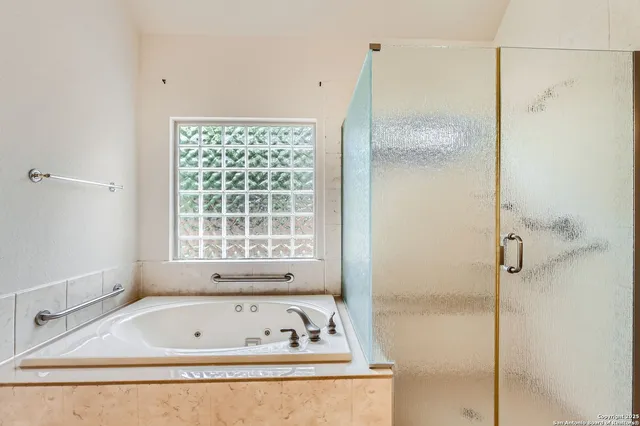 a bathroom with a bathtub and a shower