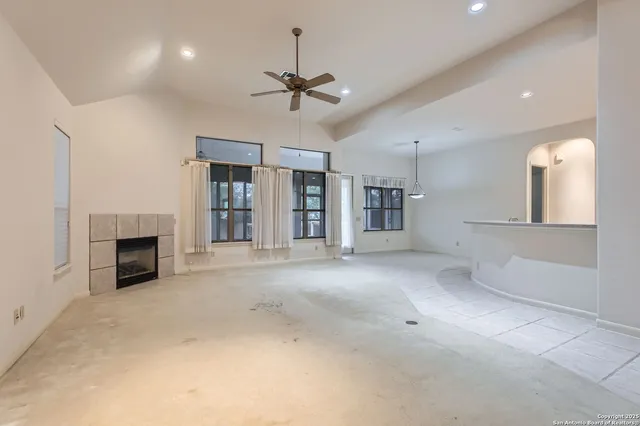 wooden floor fireplace and windows in an empty room