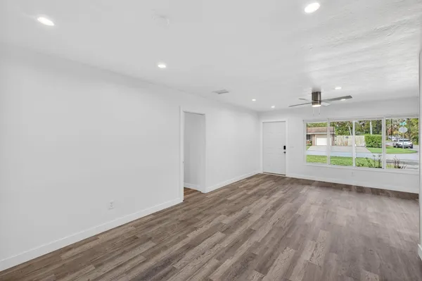 a kitchen with a sink a counter top space stainless steel appliances and cabinets