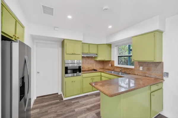 a kitchen with a sink and a stove top oven