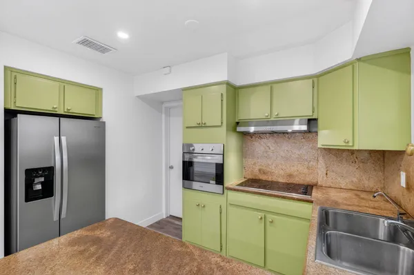 a kitchen with a sink and wooden cabinets