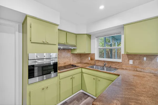a kitchen with sink and window