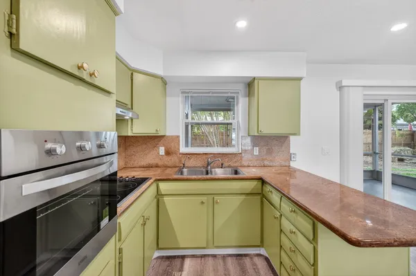 a kitchen with a sink and cabinets