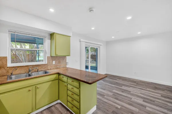 a view of a hallway with wooden floor and entryway