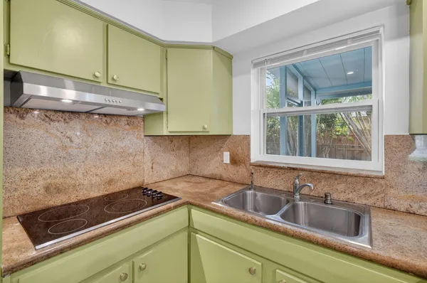 a view of a big room with wooden floor and windows