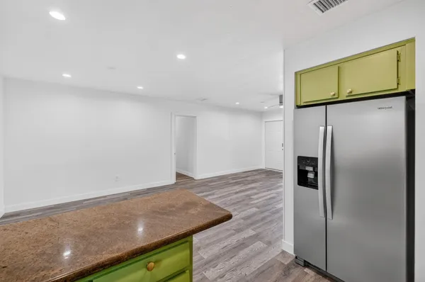 a view of a big room with wooden floor closet and windows