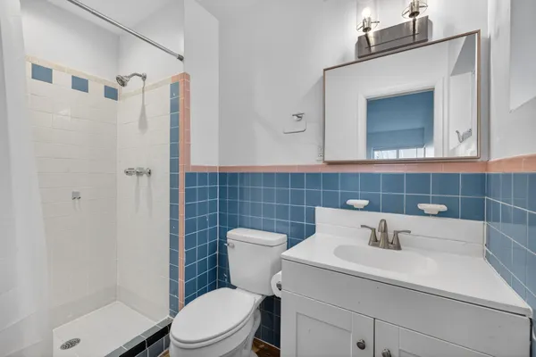 a bathroom with a shower and a glass door