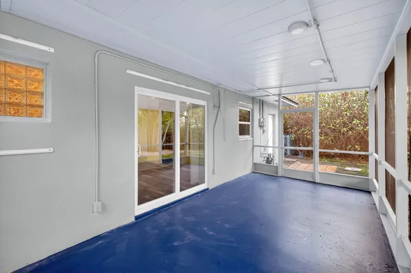 a view of a house with a yard and potted plants