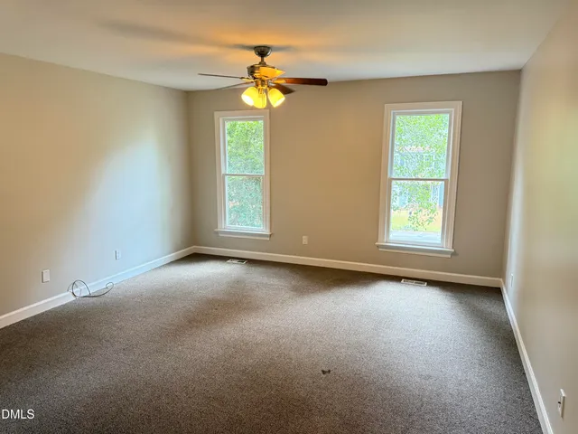 an empty room with windows and entrance