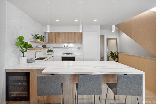 a kitchen with a table a refrigerator and a stove