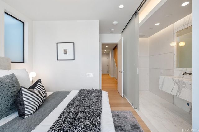 a bedroom with a bed and potted plant