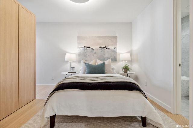 a bedroom with a bed and a chandelier