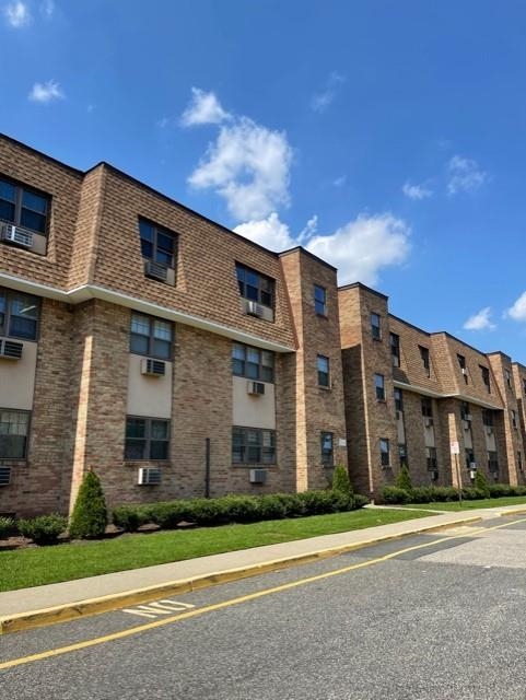 220 Meadow Lane, Unit D37 Secaucus, NJ 07094 - Photo 1 of 6 a view of a brick building next to a yard