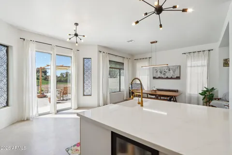 a living room with stainless steel appliances kitchen island furniture and a window