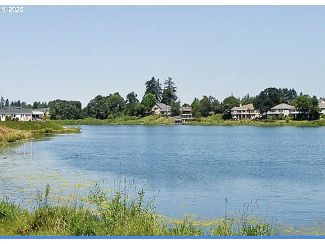 1475 Green Acres Road, Unit 76 Eugene, OR 97408 - Photo 23 of 23 a view of a lake with houses in background