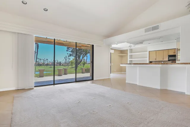 a view of a kitchen with large windows