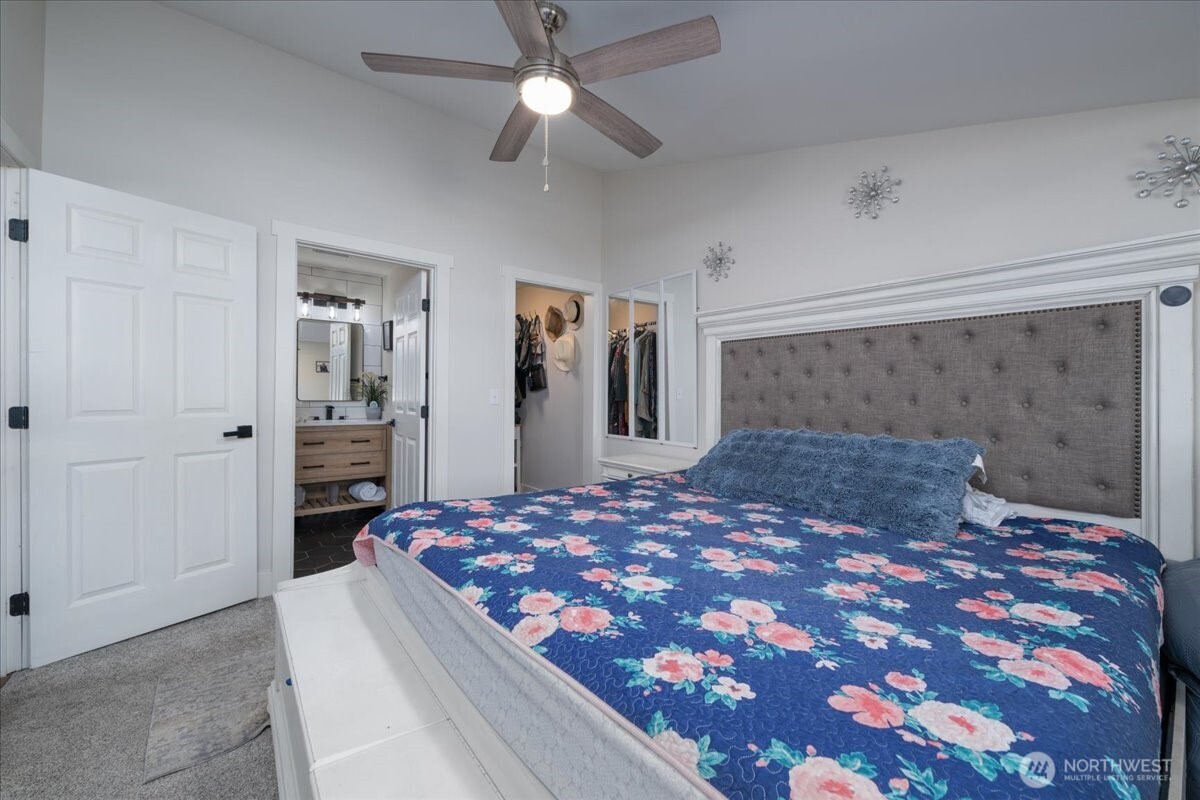 533 Fidalgo Street Sedro-Woolley, WA 98284 - Photo 12 of 37 a bedroom with a large bed and a chandelier