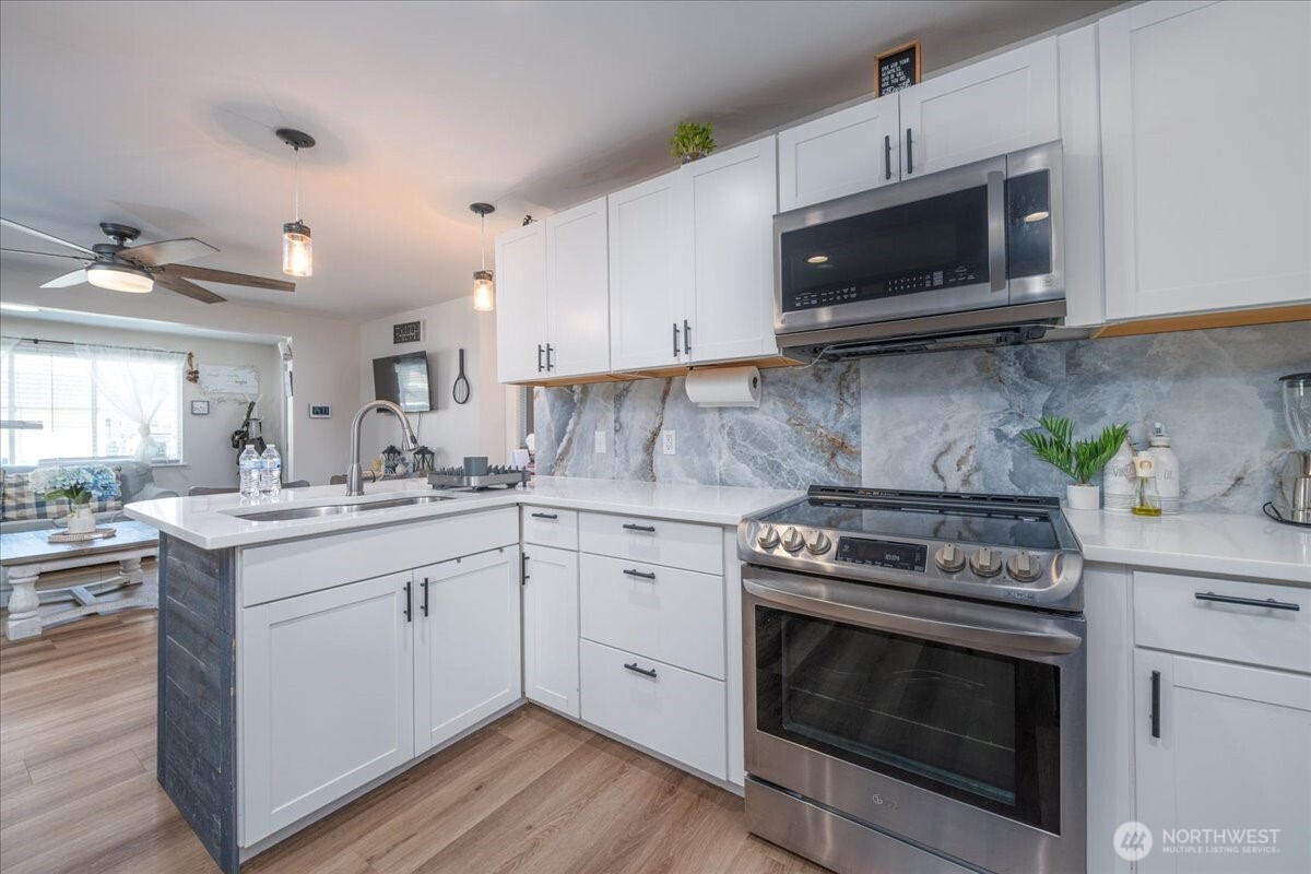 533 Fidalgo Street Sedro-Woolley, WA 98284 - Photo 7 of 37 a kitchen with a stove and a microwave