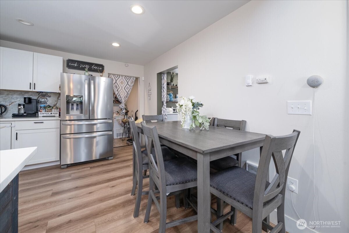 533 Fidalgo Street Sedro-Woolley, WA 98284 - Photo 9 of 37 a kitchen with stainless steel appliances a dining table chairs and wooden floor