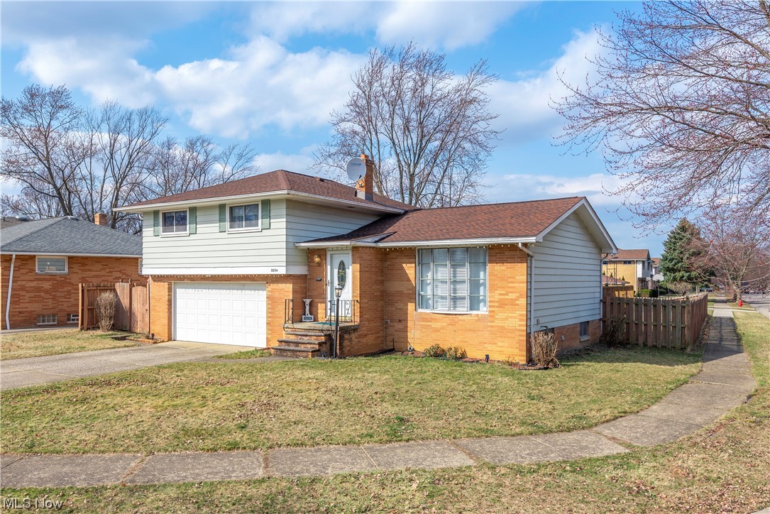 7094 Brandywine Road Parma Heights, OH 44130 - Photo 2 of 49 Tri-level home with a garage and a front lawn