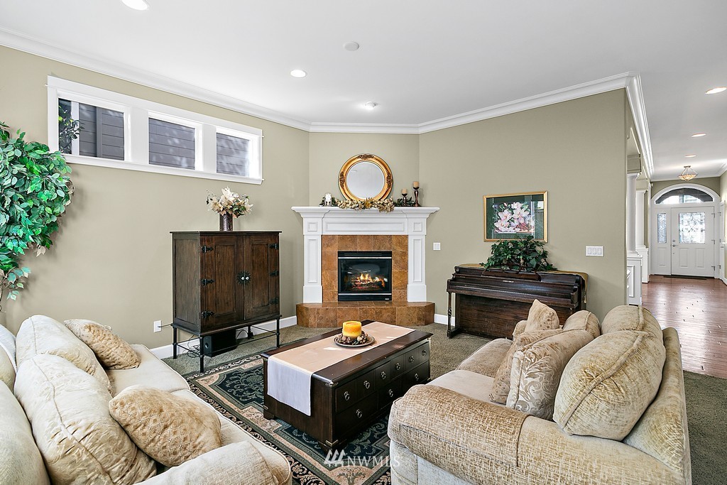 721 South 37th Place Renton, WA 98055 - Photo 14 of 34 a living room with furniture flat screen tv and a fireplace