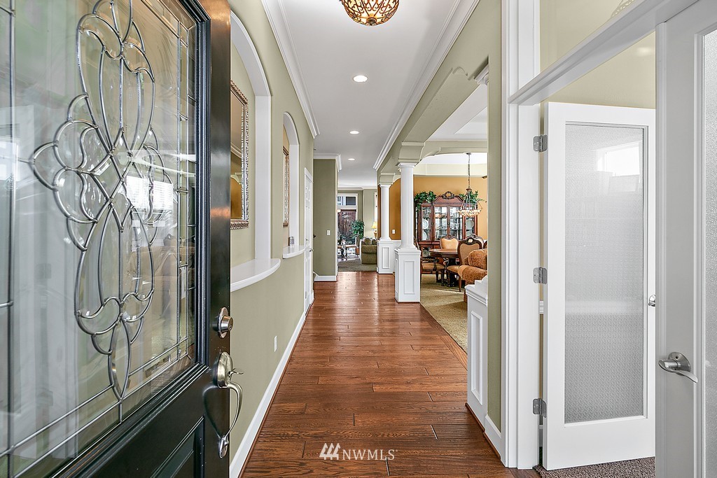 721 South 37th Place Renton, WA 98055 - Photo 4 of 34 a view of a hallway with wooden floor and glass door