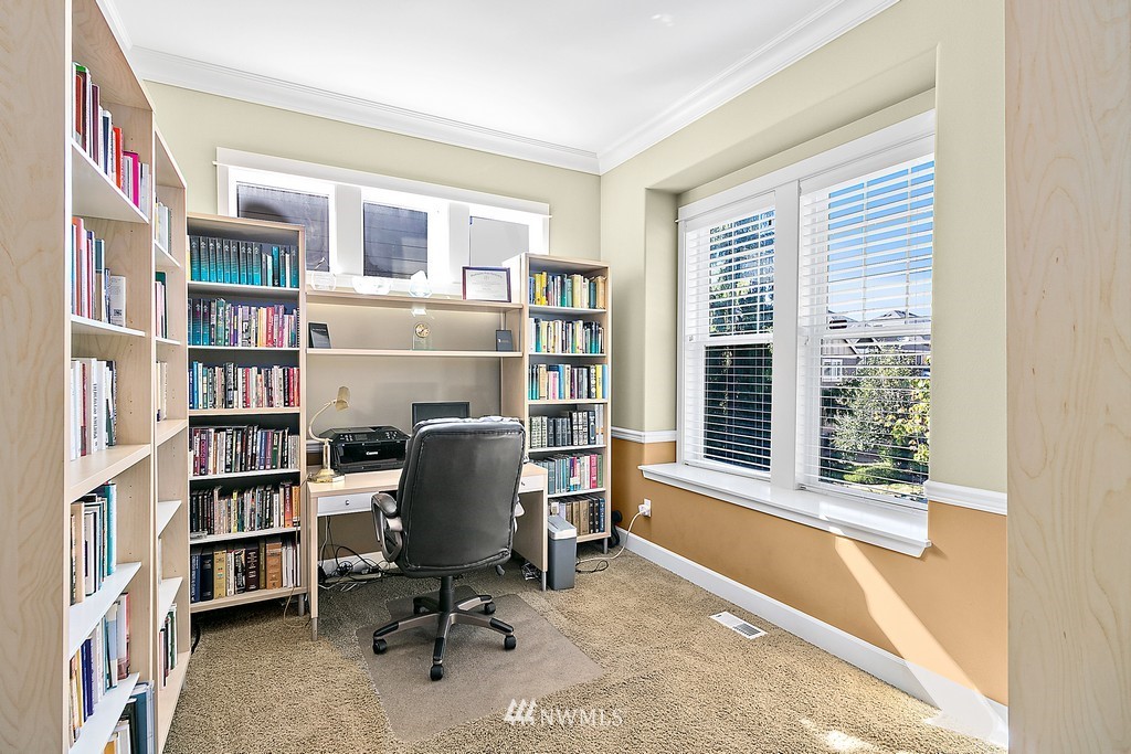 721 South 37th Place Renton, WA 98055 - Photo 5 of 34 a view of a workspace with bookshelf and a window