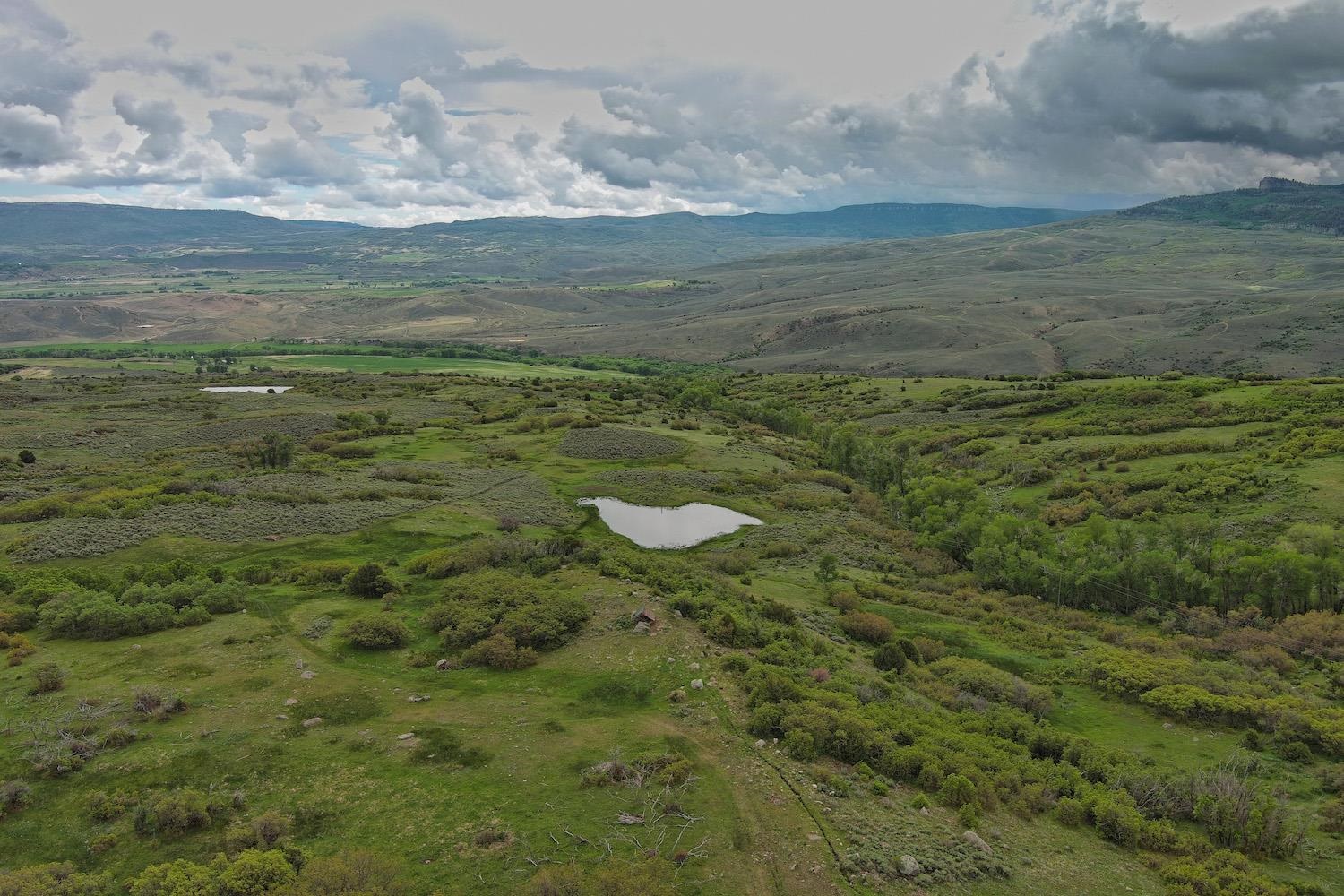22000 P77 Road Montrose, CO 81403 - Photo 4 of 37 a view of a lake with an outdoor space