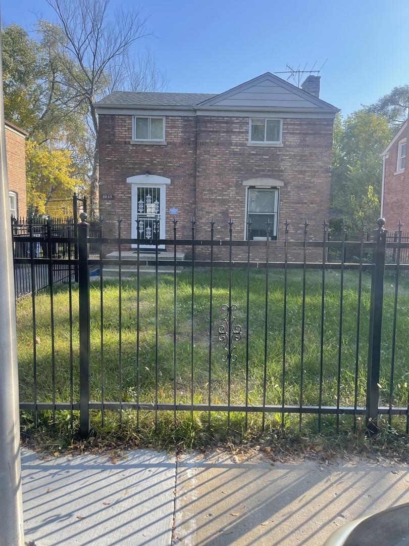 a view of a brick house in front of a yard