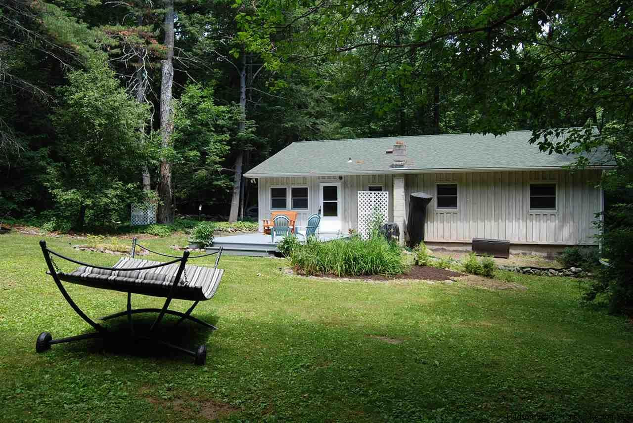 79 Iken Road Kerhonkson, NY 12446 - Photo 1 of 24 a view of a chair and table in backyard of the house