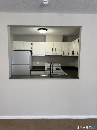 a kitchen with stainless steel appliances granite countertop a sink and a stove