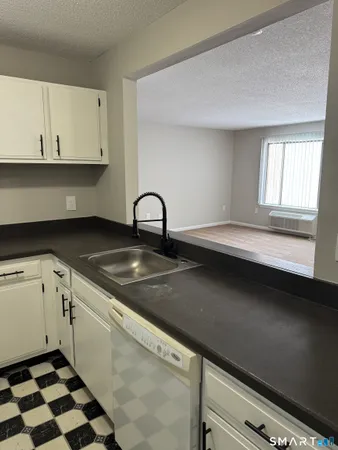 a close view of a sink a counter and appliances in the kitchen