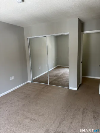 an empty room with closet area