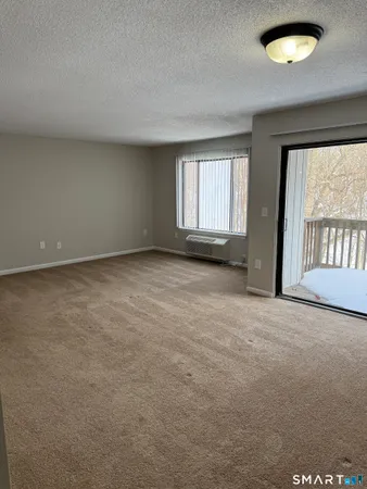 an empty room with a empty space and windows