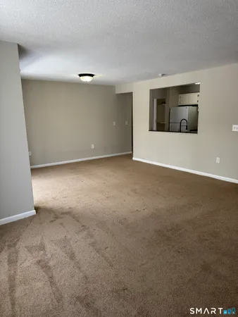 a view of an empty room with glass door