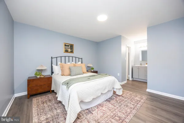 a bedroom with a bed and a lamp