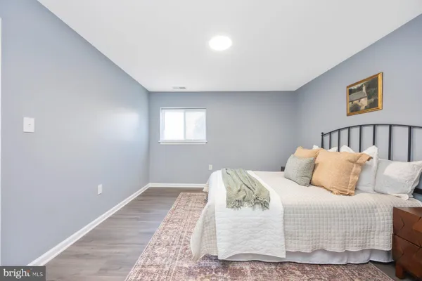 a bedroom with a bed and a night stand