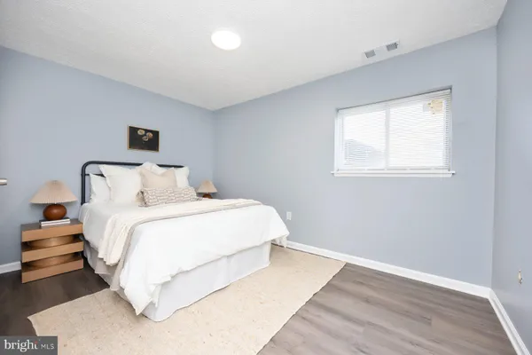 a bedroom with a bed and a night stand