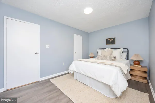 a bedroom with a bed and a night stand