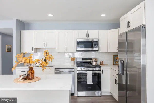 a kitchen with a sink appliances and cabinets