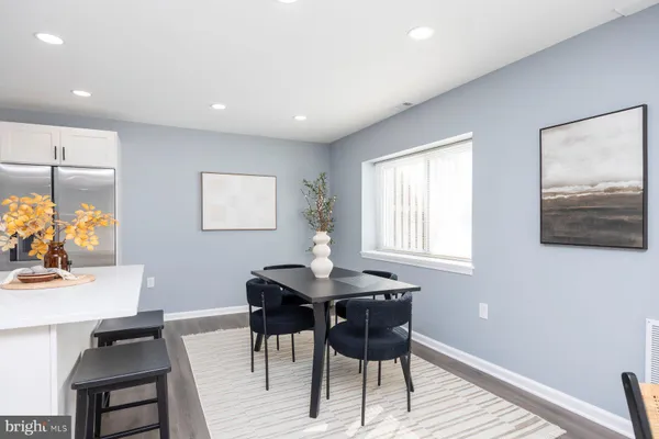 a dining room with furniture and window