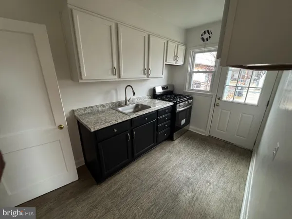 a kitchen with a sink stove and cabinets