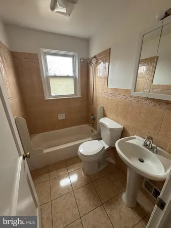 a bathroom with a sink a toilet and a bathtub