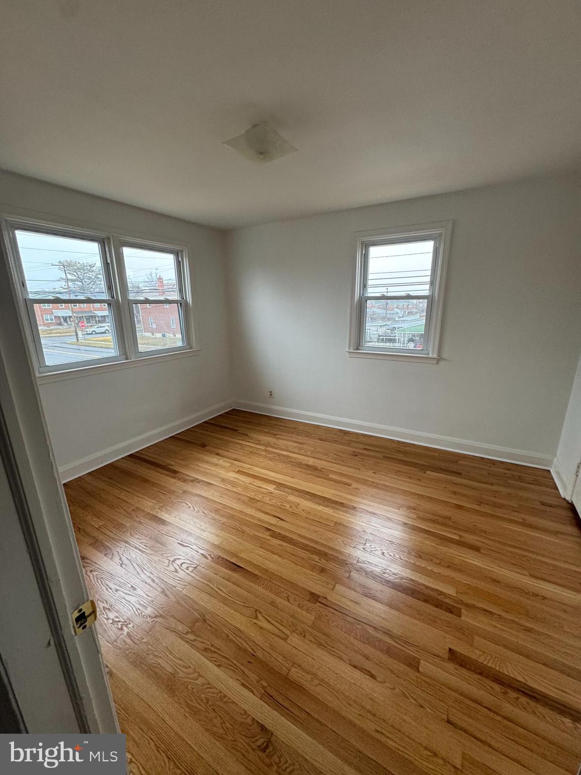 2167 Coralthorn Road Middle River, MD 21220 - Photo 17 of 23 wooden floor in an empty room with a window